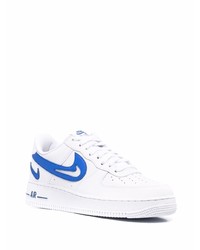 Baskets basses en cuir blanc et bleu Nike