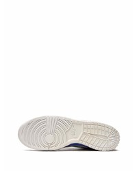 Baskets basses en cuir blanc et bleu Nike