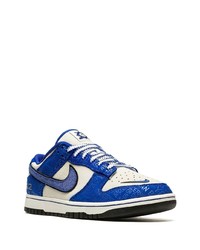 Baskets basses en cuir blanc et bleu Nike