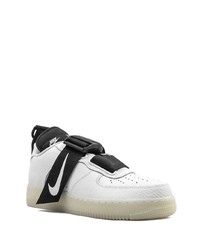 Baskets basses en cuir blanches et noires Nike