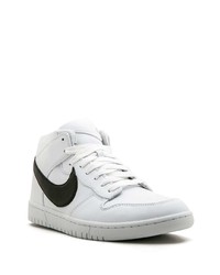 Baskets basses en cuir blanches et noires Nike