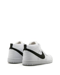 Baskets basses en cuir blanches et noires Nike