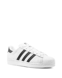 Baskets basses en cuir blanches et noires adidas