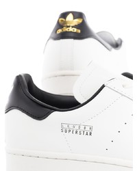 Baskets basses en cuir blanches et noires adidas