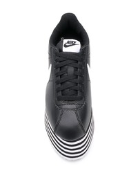 Baskets basses en cuir épaisses noires et blanches Nike