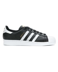 Baskets basses en cuir noires et blanches adidas