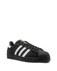 Baskets basses en cuir noires et blanches adidas