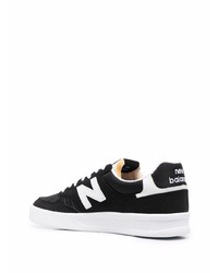 Baskets basses en daim noires et blanches New Balance