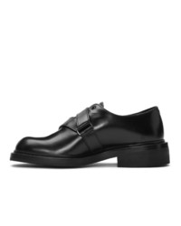 Chaussures derby en cuir noires Prada