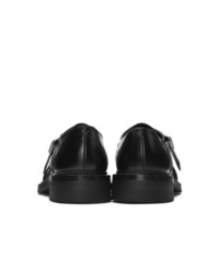 Chaussures derby en cuir noires Prada