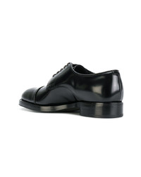 Chaussures derby en cuir noires Prada