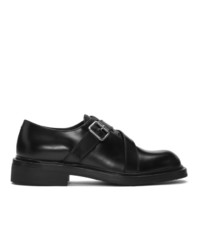 Chaussures derby en cuir noires Prada