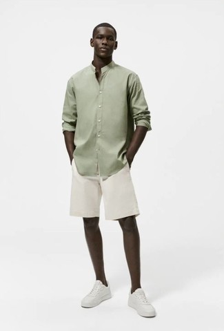 Comment s'habiller en été: Harmonise une chemise à manches longues olive avec un short blanc pour obtenir un look relax mais stylé. Une paire de baskets basses en cuir blanches est une option génial pour complèter cette tenue. C'est une tenue idéale pour cet été.