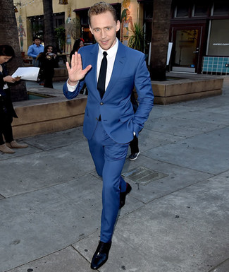Tenue de Tom Hiddleston: Costume bleu, Chemise de ville blanche, Chaussures richelieu en cuir noires, Cravate noire