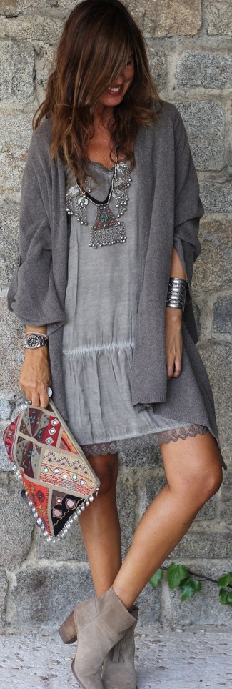 Comment porter une pochette en daim brodée grise: Marie un gilet gris foncé avec une pochette en daim brodée grise pour une tenue relax mais stylée. Cette tenue est parfait avec une paire de bottines en daim grises.