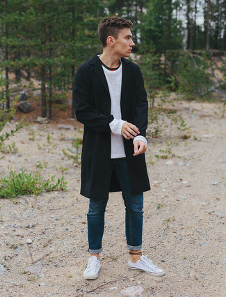 Comment porter un imperméable noir: Essaie d'associer un imperméable noir avec un jean bleu marine pour un look de tous les jours facile à porter. Cette tenue se complète parfaitement avec une paire de baskets basses en toile blanches.