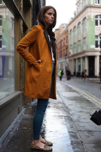 Comment porter des slippers en daim imprimés léopard marron clair: Pense à harmoniser un manteau orange avec un jean skinny bleu pour obtenir un look relax mais stylé. Complète ce look avec une paire de slippers en daim imprimés léopard marron clair.