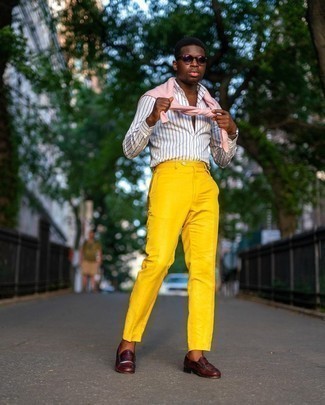 Comment porter un pantalon de costume moutarde: Pense à porter un pull à col rond rose et un pantalon de costume moutarde pour un look pointu et élégant. Termine ce look avec une paire de slippers en cuir bordeaux.