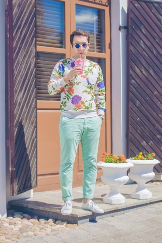 Comment porter un pantalon chino vert: Pense à marier un pull à col rond à fleurs blanc avec un pantalon chino vert pour obtenir un look relax mais stylé. Cette tenue est parfait avec une paire de baskets basses en cuir blanches.