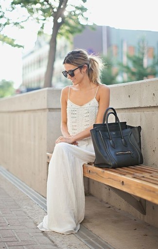 Comment porter un sac fourre-tout en cuir noir en été à 30 ans: Associe une robe longue ornée de perles blanche avec un sac fourre-tout en cuir noir pour une tenue relax mais stylée. On trouve ce look canon pour pour les journées estivales.
