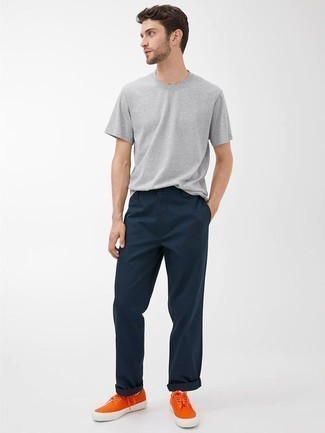 Tenue: T-shirt à col rond gris, Pantalon chino bleu marine, Baskets basses en toile orange