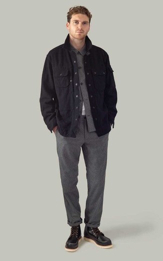 Comment porter un pantalon chino en laine gris foncé: Opte pour une veste-chemise noire avec un pantalon chino en laine gris foncé pour créer un look chic et décontracté. Termine ce look avec une paire de bottes de loisirs en cuir noires.