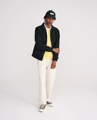 Un polo à porter avec un pantalon chino blanc et noir