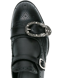 Monks en cuir noirs Gucci