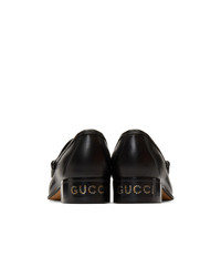 Slippers en cuir noirs Gucci