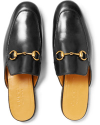 Slippers en cuir noirs Gucci